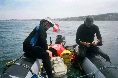 John smiles as Ron splits a scallop - John’s smiling because he thinks our love for sushi is disgusting.