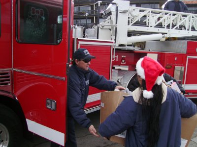 A fireman accepts the donated toys.