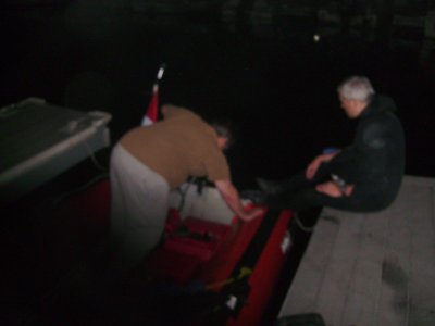 John looks at the engine while Ron supervises.