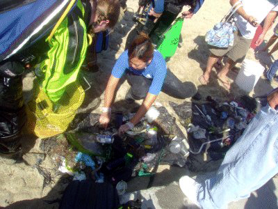 A volunteer looks for lost wallets and money.