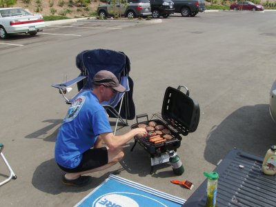 Hamburgers and hotdogs on the outdoor stove.