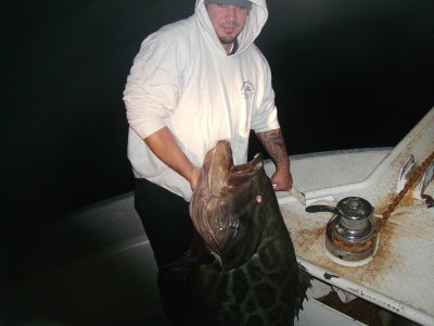 The deckhand with the 110 pound Grupper.