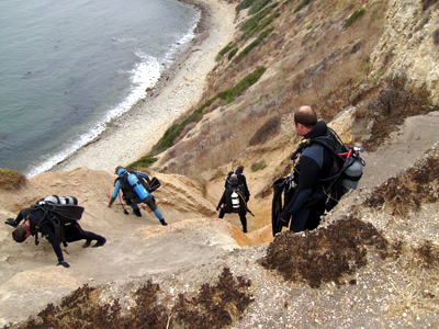 SCUBA Divers climb down Honeymoon Cove.